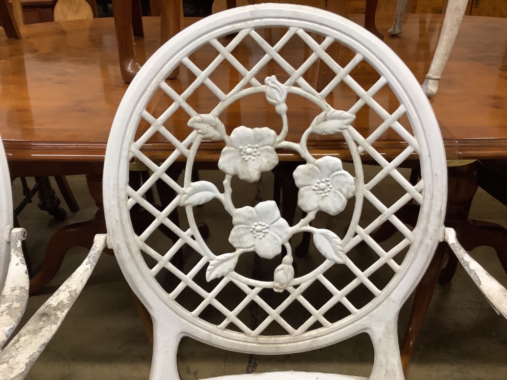 A set of four white painted alumiunum garden elbow chairs, width 57cm depth 55cm height 98cm